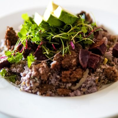 purple cauliflower rice bowl with ground venison, purple potatoes, microgreens and sundried tomatoes