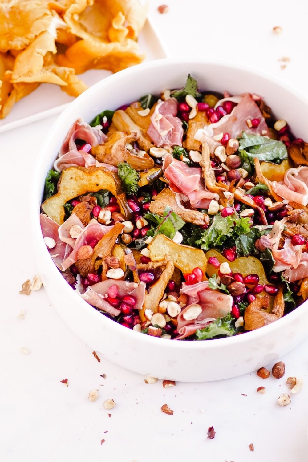 Beautiful Fall Kale Salad with Chanterelle Mushrooms, Acorn Squash, Prosciutto, and Pomegranates | Recipe